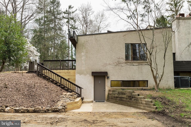 390 S Bryn Mawr Ave, Bryn Mawr, PA 19010 - view of front of property with stairs, central AC unit, stucco siding, and a patio