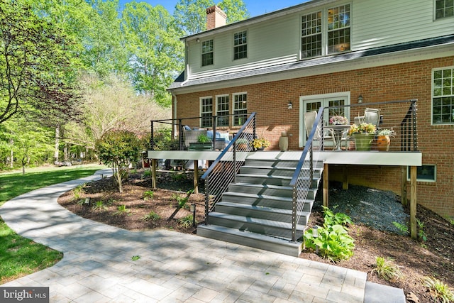 208 Biggs Purchase Ln, Lothian, MD 20711 - exterior space featuring brick siding, stairs, a chimney, and a deck
