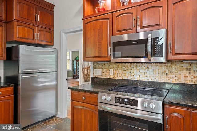 208 Biggs Purchase Ln, Lothian, MD 20711 - kitchen with dark stone counters, baseboards, tasteful backsplash, and stainless steel appliances
