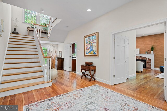 208 Biggs Purchase Ln, Lothian, MD 20711 - stairs with a brick fireplace, recessed lighting, baseboards, and wood finished floors