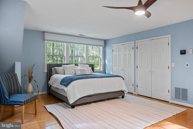 208 Biggs Purchase Ln, Lothian, MD 20711 - bedroom featuring visible vents, two closets, wood finished floors, baseboards, and a ceiling fan
