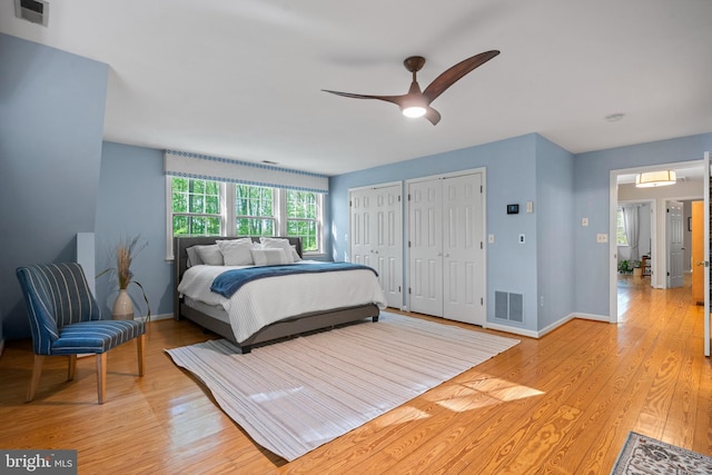 208 Biggs Purchase Ln, Lothian, MD 20711 - bedroom with multiple closets, baseboards, light wood finished floors, and visible vents