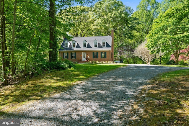 208 Biggs Purchase Ln, Lothian, MD 20711 - cape cod home featuring gravel driveway, a front lawn, and a chimney