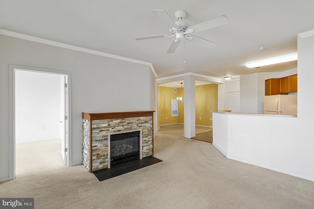 unfurnished living room with light carpet, baseboards, ceiling fan, crown molding, and a fireplace