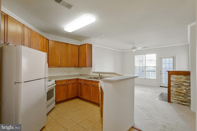 kitchen with light countertops, visible vents, white appliances, a peninsula, and ceiling fan