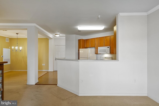 kitchen with visible vents, light colored carpet, a notable chandelier, and white appliances