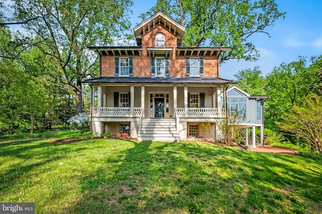 view of front of house featuring a porch, stairs, and a front yard