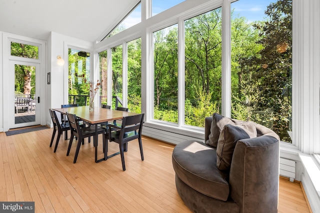 sunroom featuring hardwood / wood-style flooring and lofted ceiling