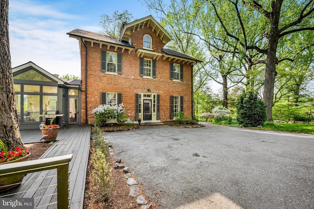 view of front of property with brick siding and aphalt driveway