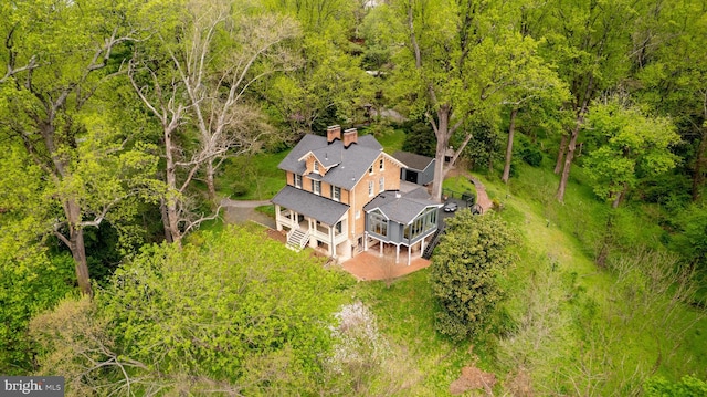 drone / aerial view featuring a forest view