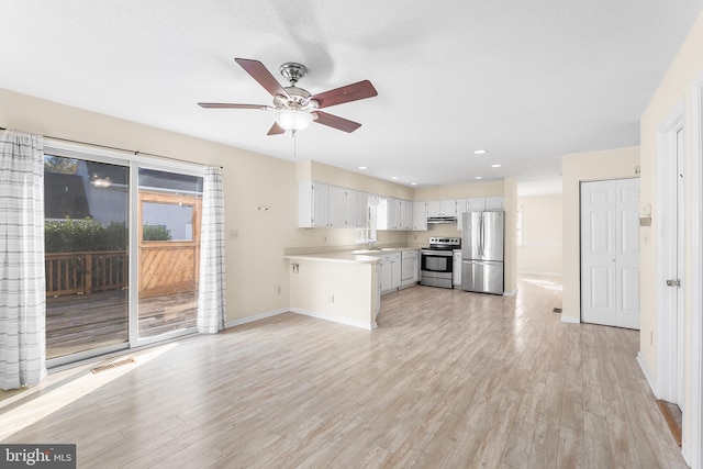 kitchen with light countertops, a ceiling fan, stainless steel appliances, light wood-style flooring, and extractor fan