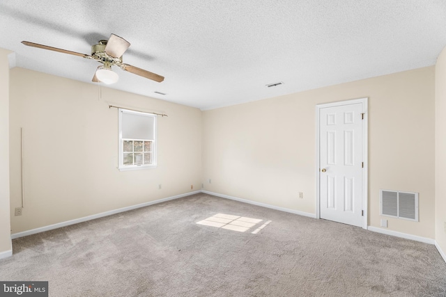 unfurnished room with ceiling fan, baseboards, visible vents, and carpet floors