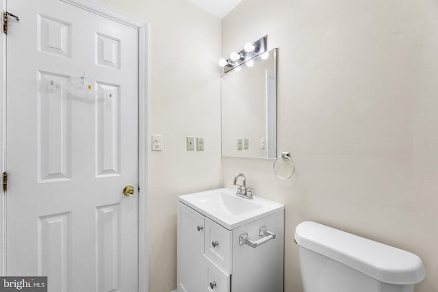 bathroom featuring toilet and vanity