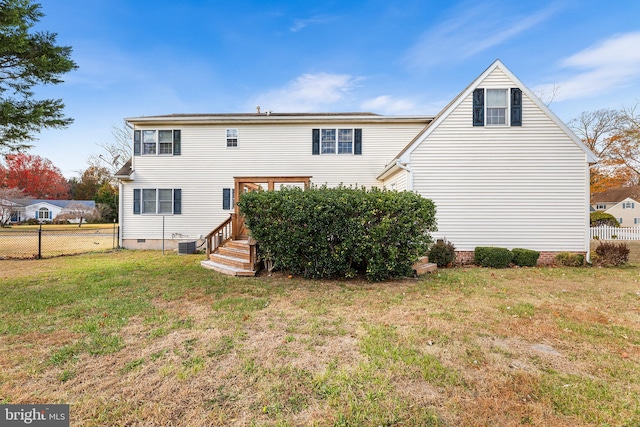 rear view of house with a yard, fence, crawl space, and central air condition unit