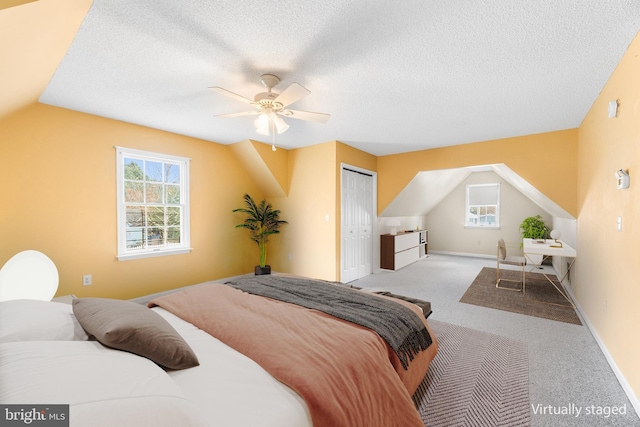 bedroom with a closet, carpet flooring, and a textured ceiling