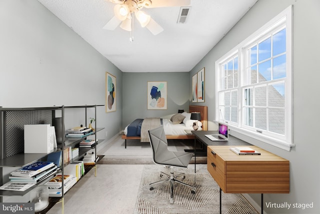 office area with ceiling fan, baseboards, visible vents, and carpet floors