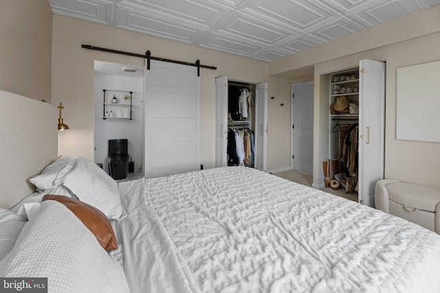 bedroom with a closet, a barn door, and an ornate ceiling