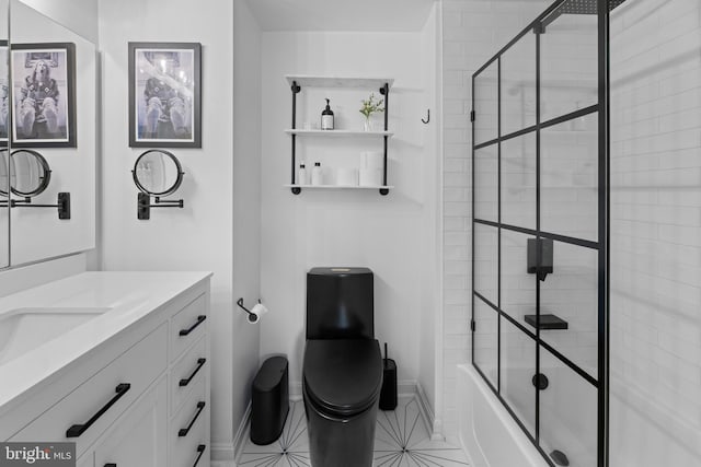 full bathroom featuring toilet, tile patterned floors, vanity, and bath / shower combo with glass door