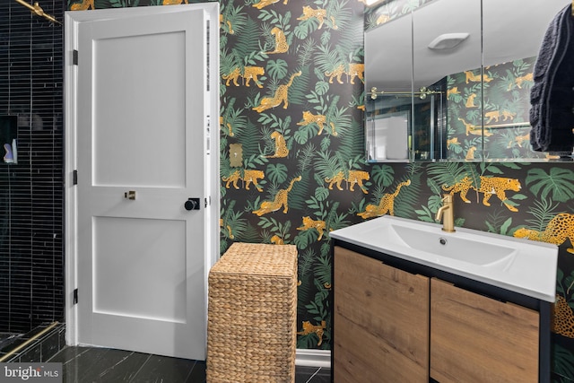 bathroom with vanity and wallpapered walls