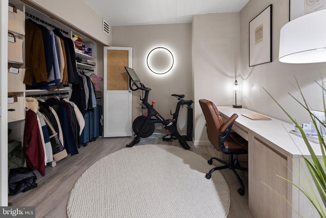 home office with visible vents and wood finished floors