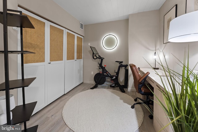 office area featuring light wood-style floors and visible vents