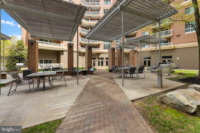 view of home's community with a pergola, a patio area, and outdoor dining space
