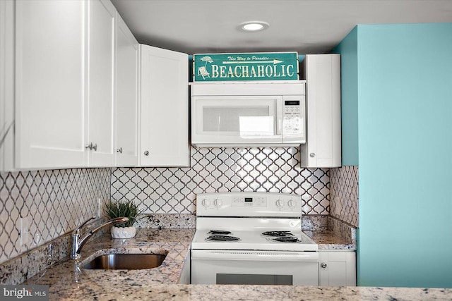 13500 Coastal Hwy Unit 201, Ocean City, MD 21842 - kitchen featuring tasteful backsplash, a sink, white appliances, white cabinetry, and light stone counters