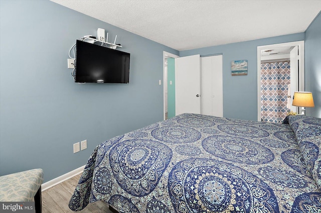 13500 Coastal Hwy Unit 201, Ocean City, MD 21842 - bedroom with wood finished floors, baseboards, and a closet