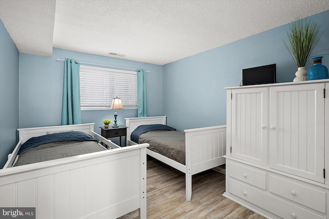 13500 Coastal Hwy Unit 201, Ocean City, MD 21842 - bedroom featuring visible vents, wood finished floors, and a textured ceiling