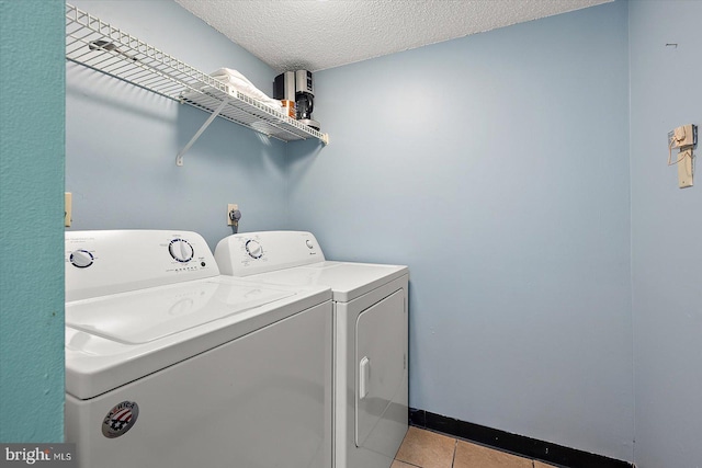 13500 Coastal Hwy Unit 201, Ocean City, MD 21842 - washroom with washer and dryer, laundry area, light tile patterned floors, and a textured ceiling