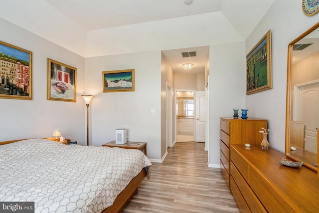 bedroom with light wood-type flooring and baseboards