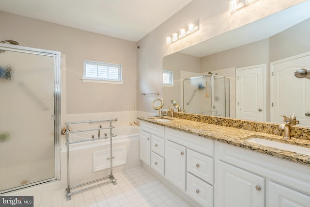 bathroom featuring a shower stall, a bath, double vanity, and tile patterned floors