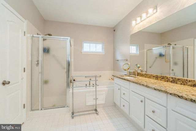 full bath with a shower stall, a bath, vanity, and tile patterned flooring