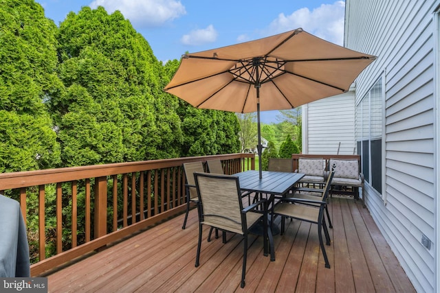 wooden terrace featuring outdoor dining area