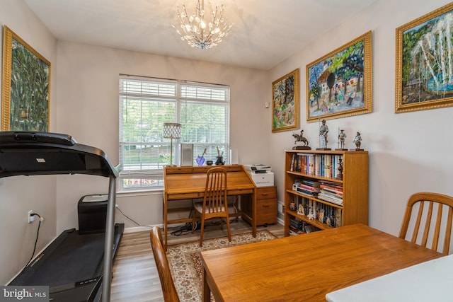 office space with wood finished floors, a chandelier, and baseboards