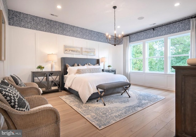1201 Chesapeake View Dr, Middletown, DE 19709 - bedroom featuring light wood-style floors, a decorative wall, visible vents, and a chandelier