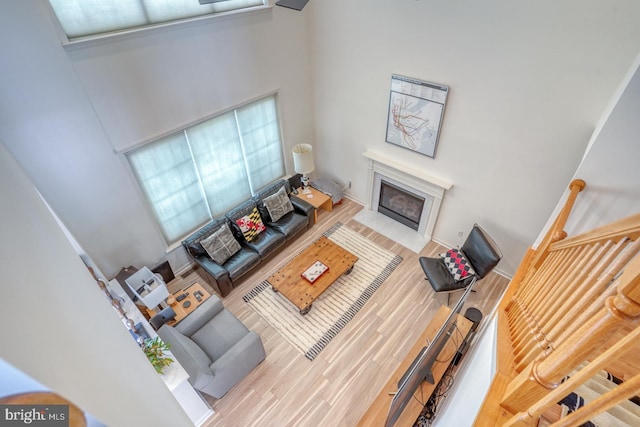 17 Fairway St, Milford, DE 19963 - living area with a fireplace with flush hearth, a towering ceiling, and wood finished floors