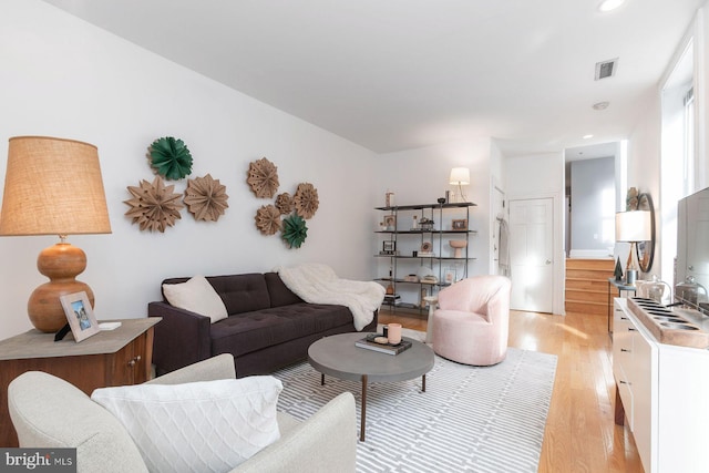 living room with visible vents, recessed lighting, and light wood-style floors