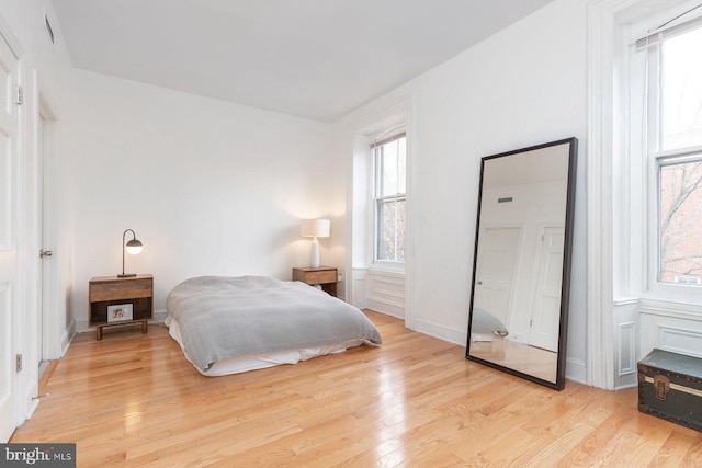 bedroom with baseboards and light wood-style floors