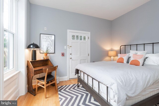 bedroom with light wood-style floors and baseboards