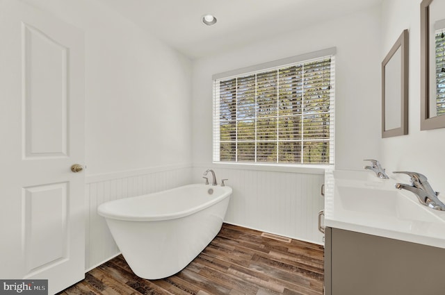2208 Quarry Rd, Bunker Hill, WV 25413 - full bathroom featuring wainscoting, vanity, a freestanding tub, wood finished floors, and visible vents