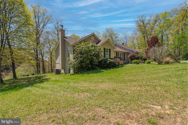 2208 Quarry Rd, Bunker Hill, WV 25413 - view of side of property featuring a lawn, a chimney, and central AC unit
