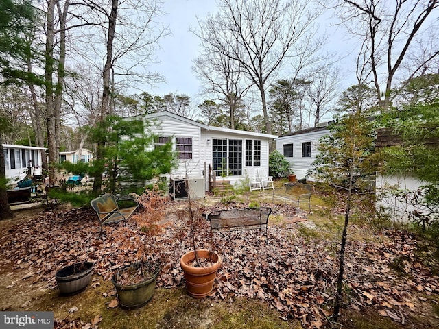 back of house featuring a vegetable garden