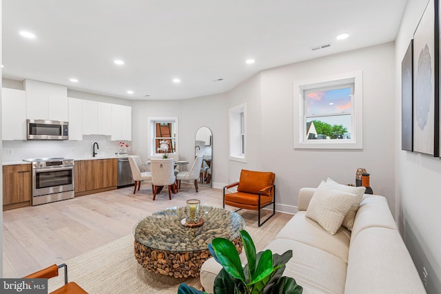 1724 Connecticut Ave NW Unit 1, Washington, DC 20009 - living area with light wood finished floors, recessed lighting, and baseboards