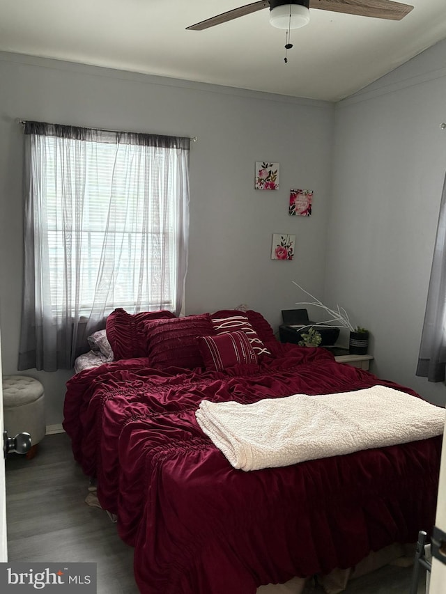 bedroom with wood finished floors, a ceiling fan, and lofted ceiling