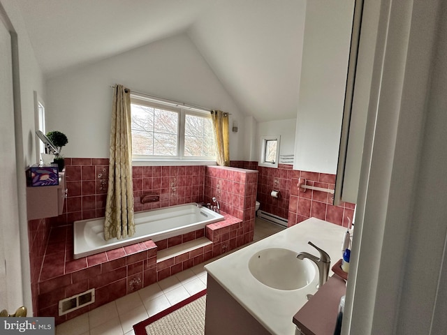 bathroom featuring visible vents, vaulted ceiling, tile walls, vanity, and tile patterned flooring