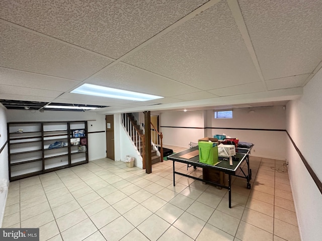 game room with tile patterned floors and a drop ceiling
