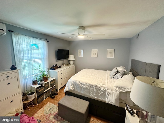 bedroom with visible vents, a ceiling fan, and light wood-style flooring