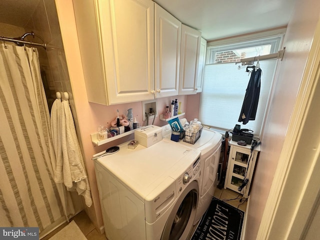 laundry area with cabinet space, independent washer and dryer, and tile patterned floors