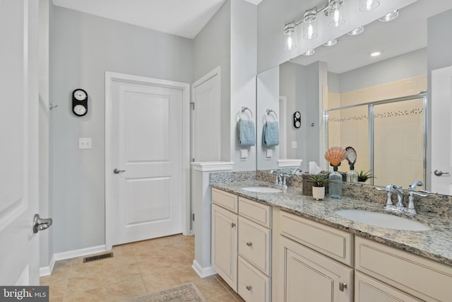 bathroom with visible vents, a sink, baseboards, and a shower stall